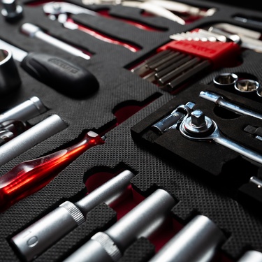A close-up of a professional red and silver work tools set for automotive technicians in a stylish box.
