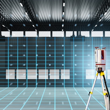 A 3D scanner sitting on a tripod in the middle of an empty room. The room is covered in blue grid lines.