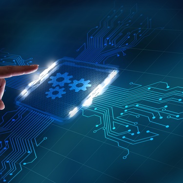 A human hand preparing to press a graphic of a button. The button has gears on it and circuits spreading from it.