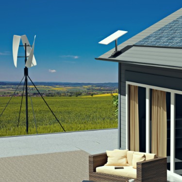 A one-story home with multiple solar panels on the roof, an AC unit, and a teak couch, on a large empty field.